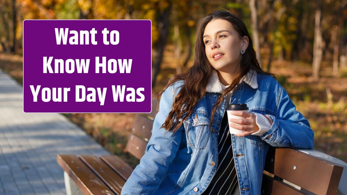 A young attractive woman is sitting on a bench in an autumn park with a cup of coffee.