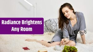 Portrait of smiling young woman sitting on bed at home.